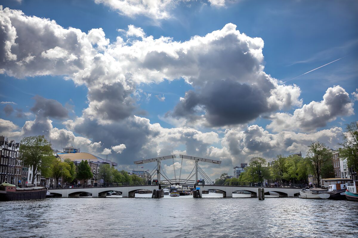 White drawbridge beneath billowing clouds