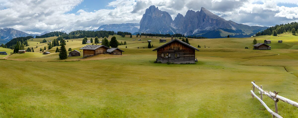 Wooden huts beneath jagged peaks