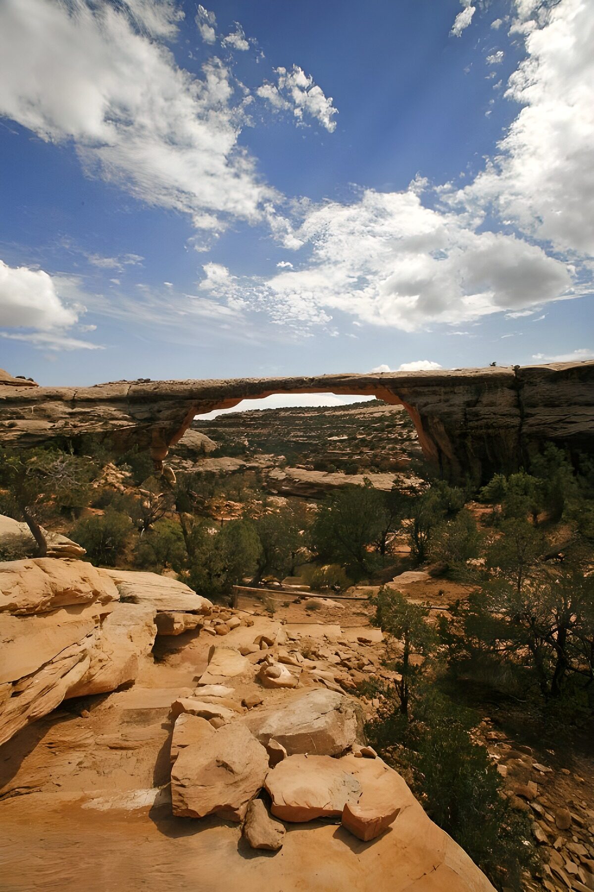 Rock arch beneath a wide blue sky