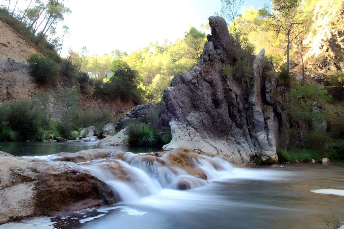 Rocky cascades in a sunlit gorge