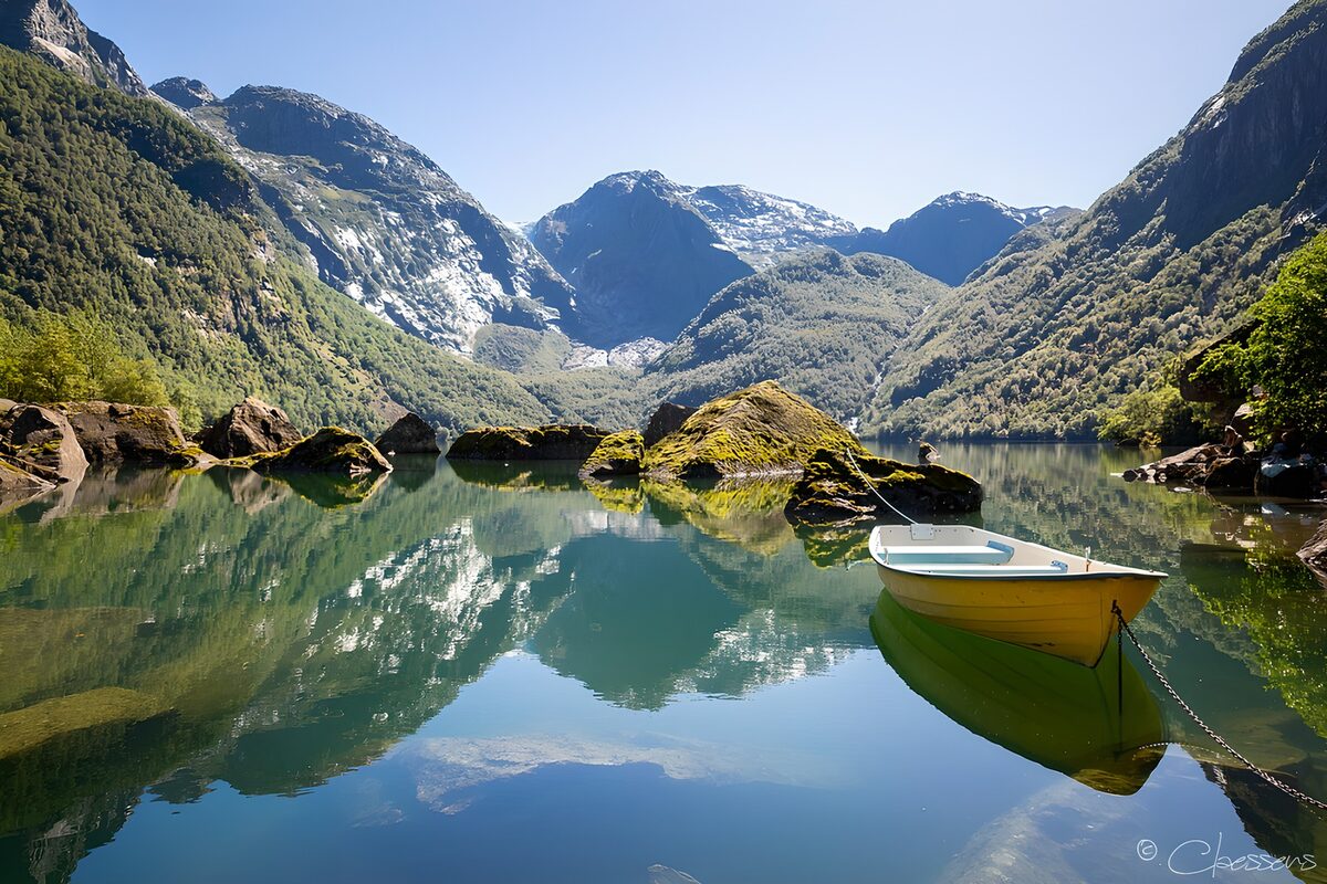 Yellow boat on a still mountain lake