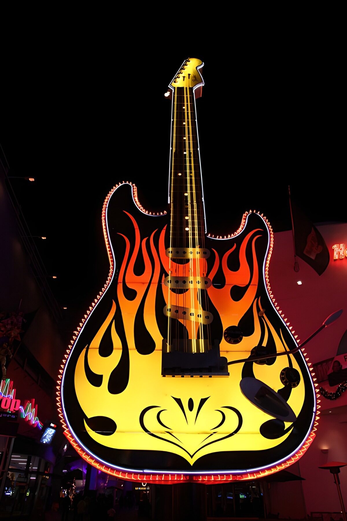 Giant electric guitar in a fiery glow