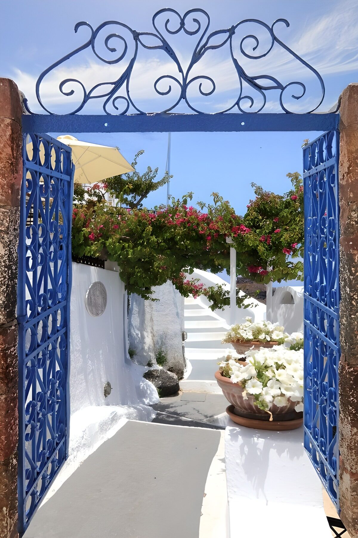 Blue gates to a sunlit courtyard