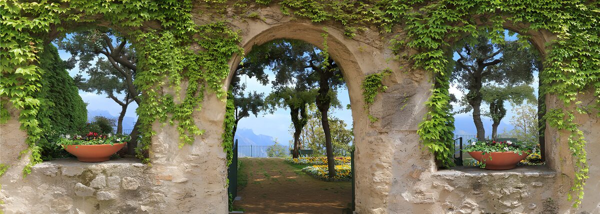 Three sunlit arches in a leafy stone wall