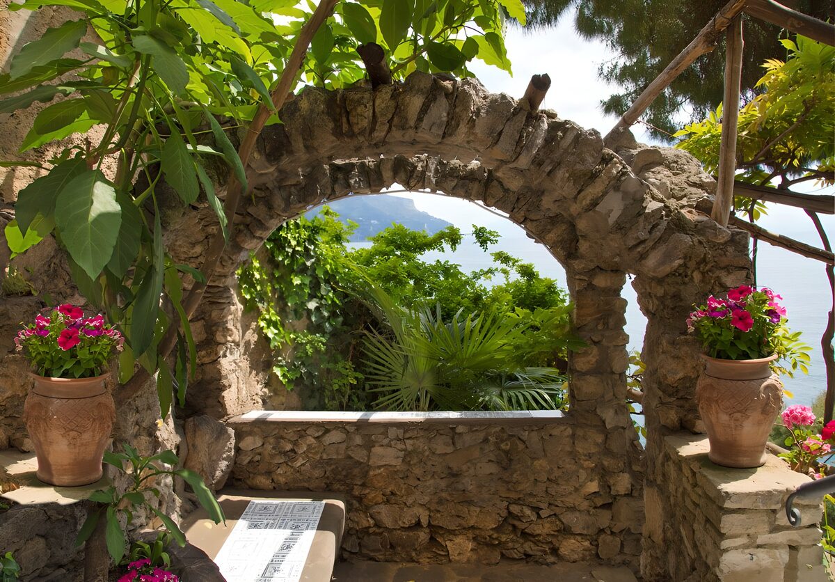 Sunlit stone arch with a sea view