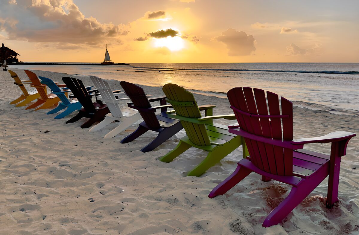 Colourful beach chairs at sunset
