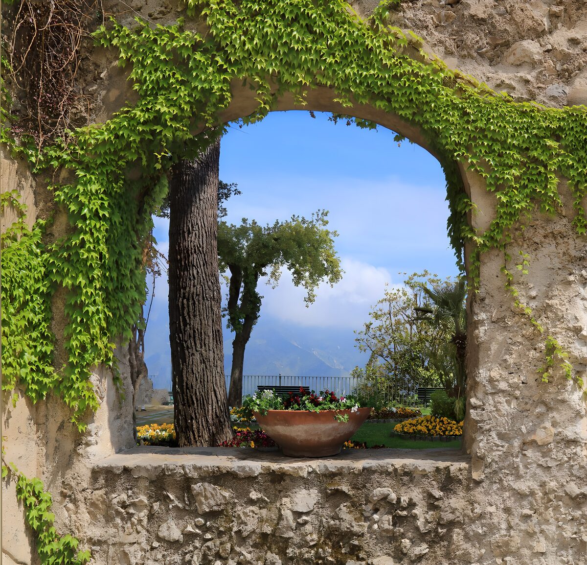 Garden view through a sunlit stone arch
