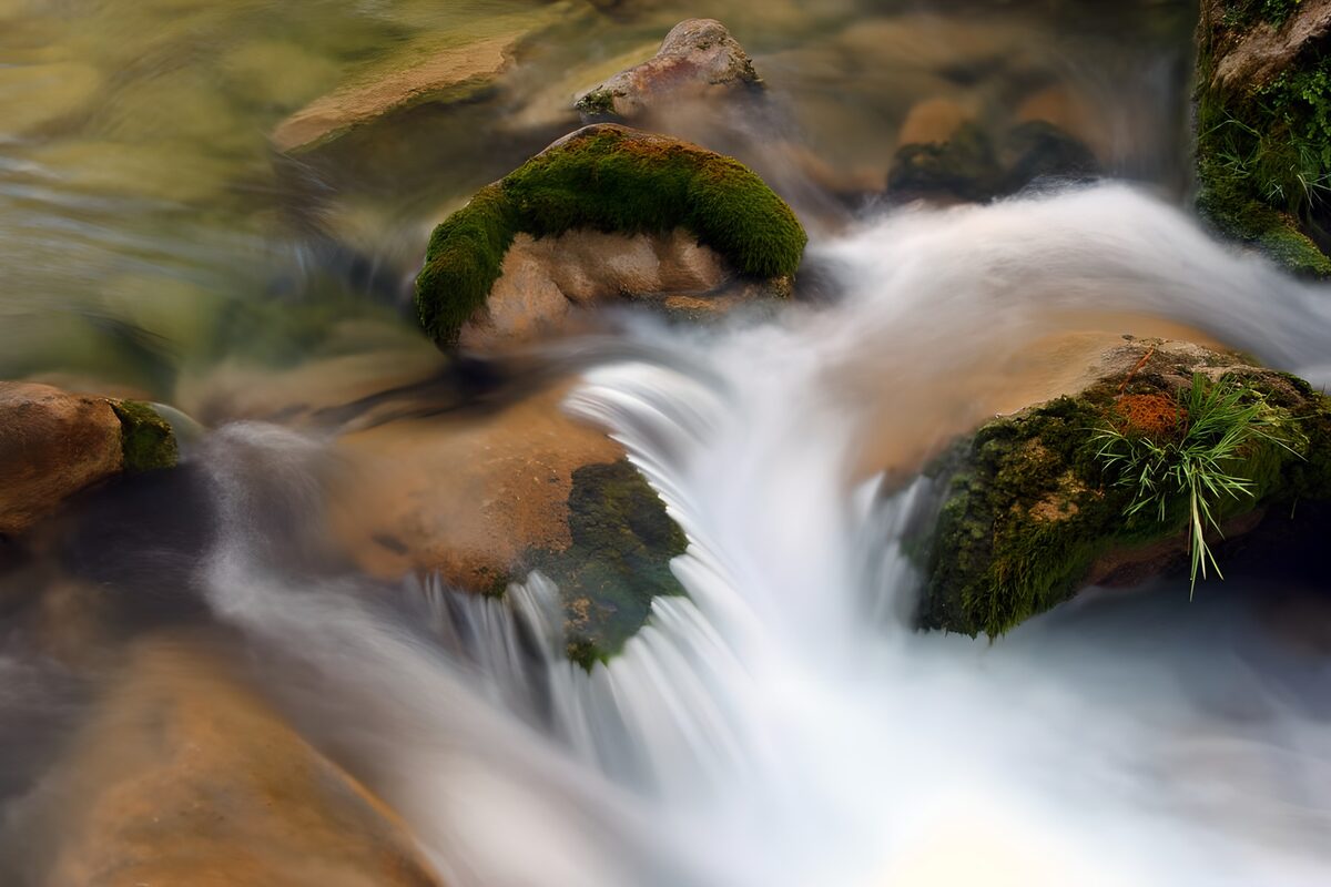 Soft cascades over mossy rocks