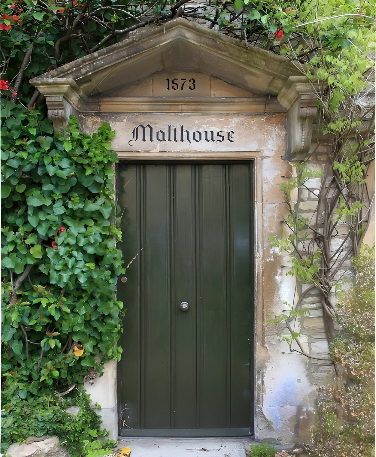 Green door in a timeworn stone entrance