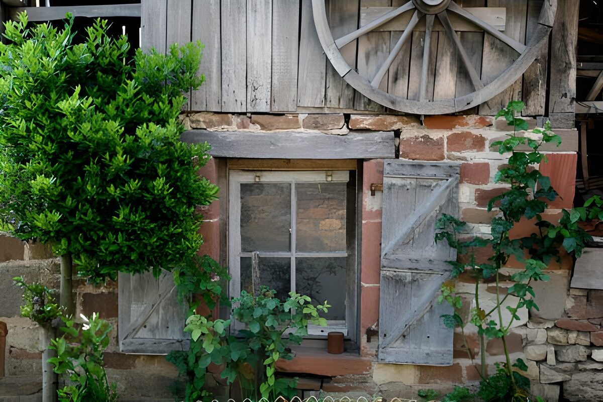 Rustic window beneath a wagon wheel