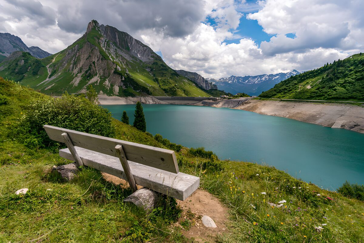 Turquoise reservoir beneath rugged peaks
