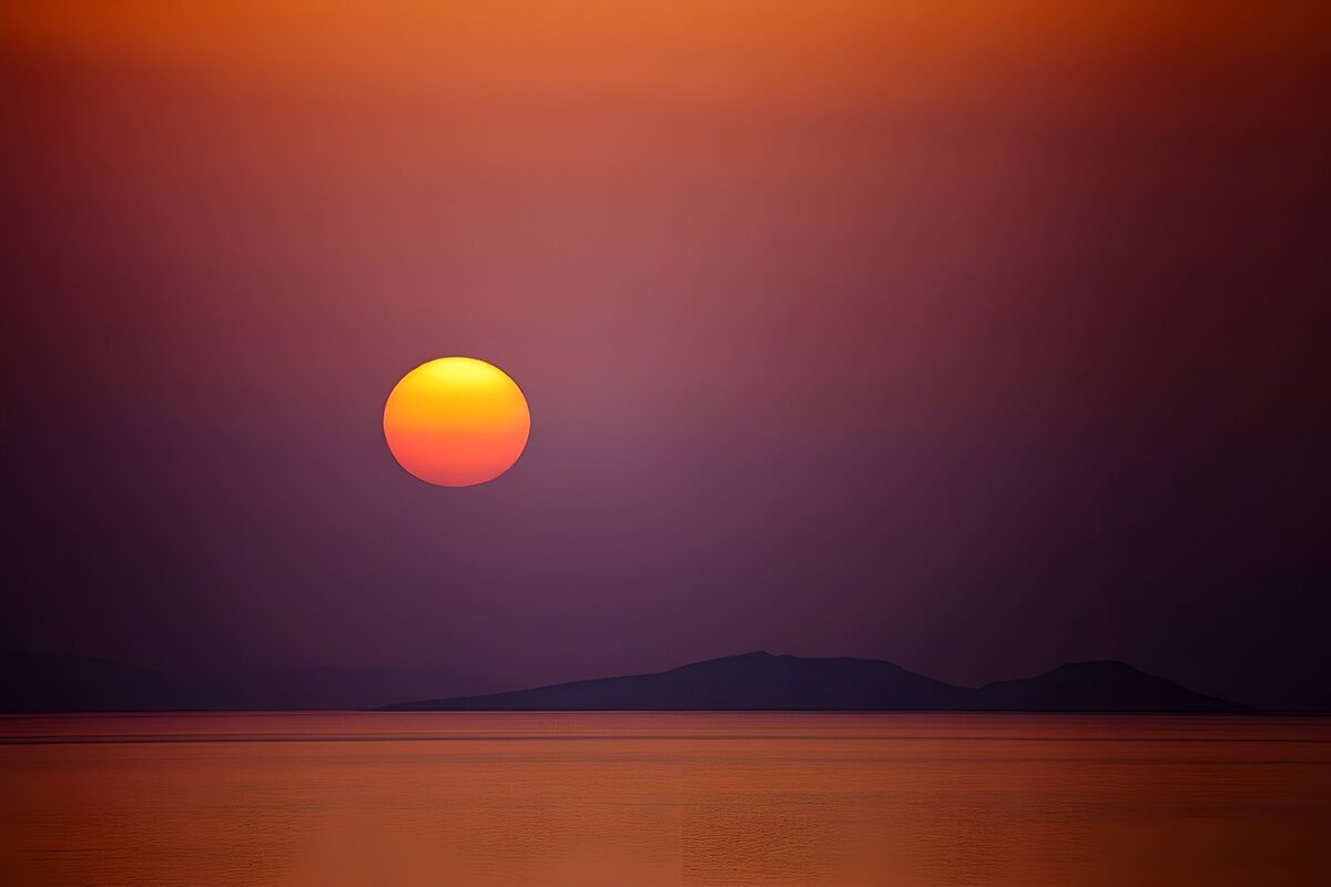 Orange sunset beyond dark islands