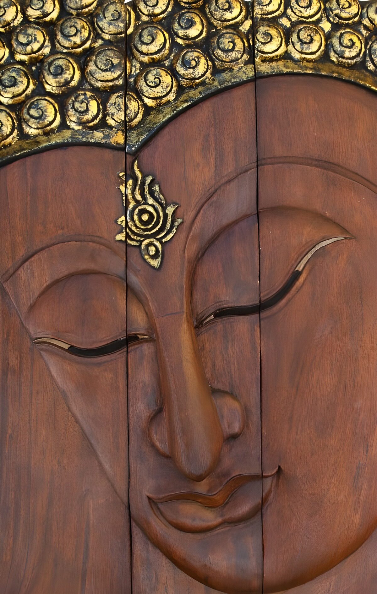 Carved wooden Buddha with a quiet smile