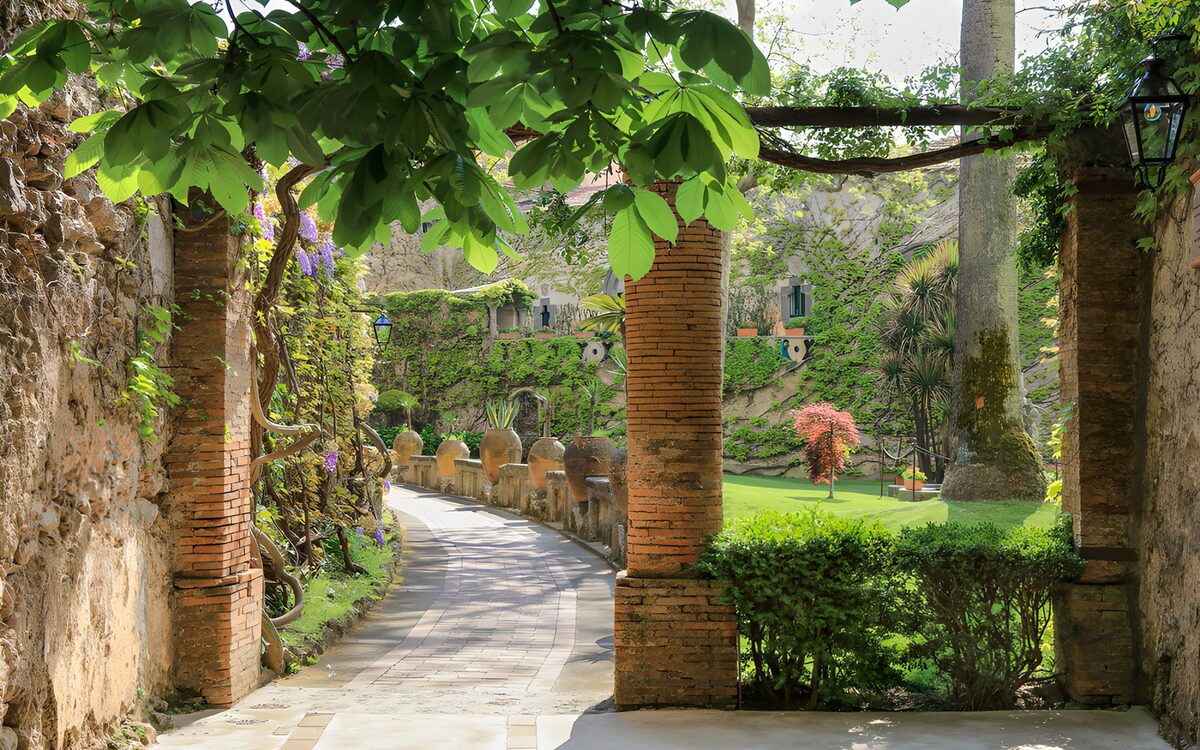 Shaded garden through rustic brick pillars