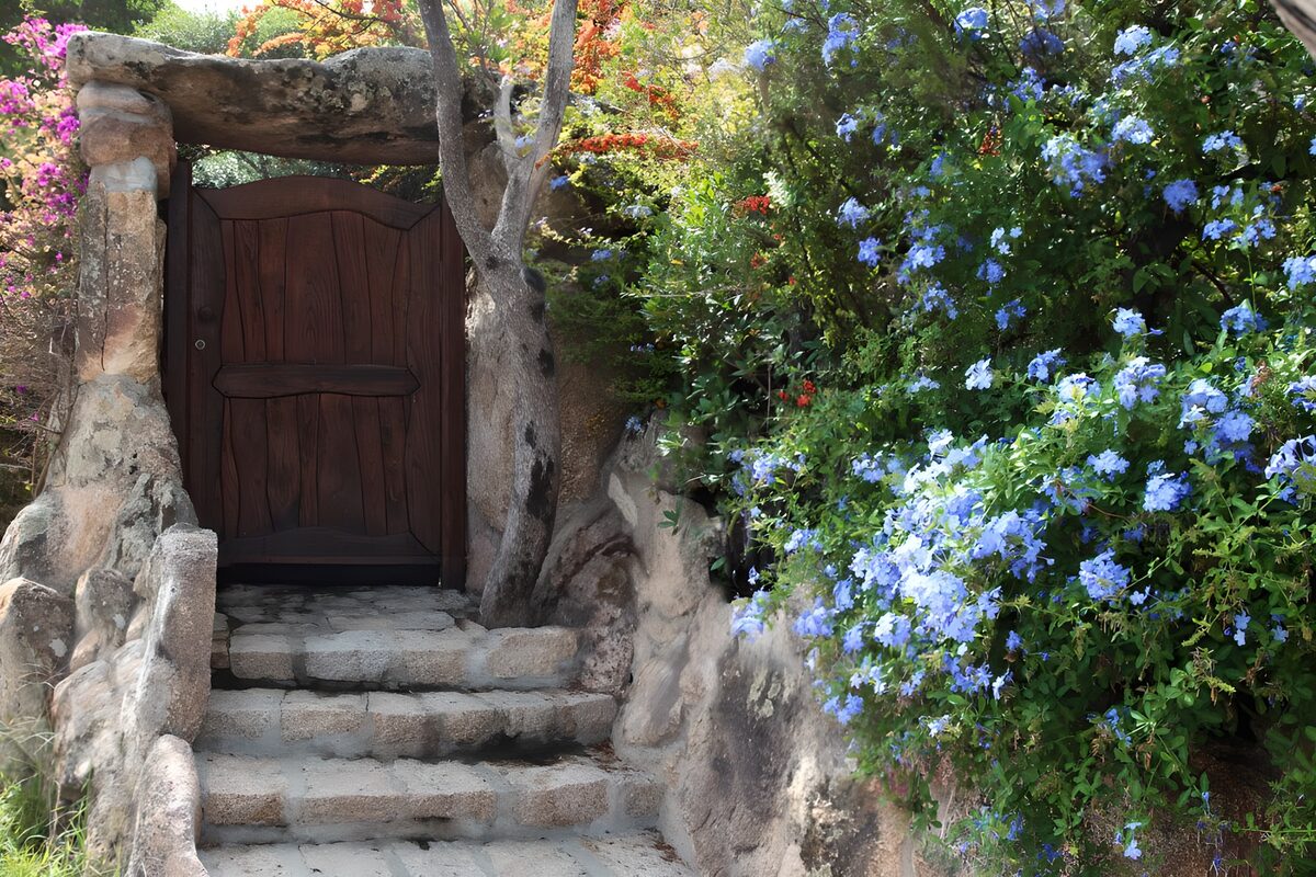 Wooden gate and flower-lined stone steps