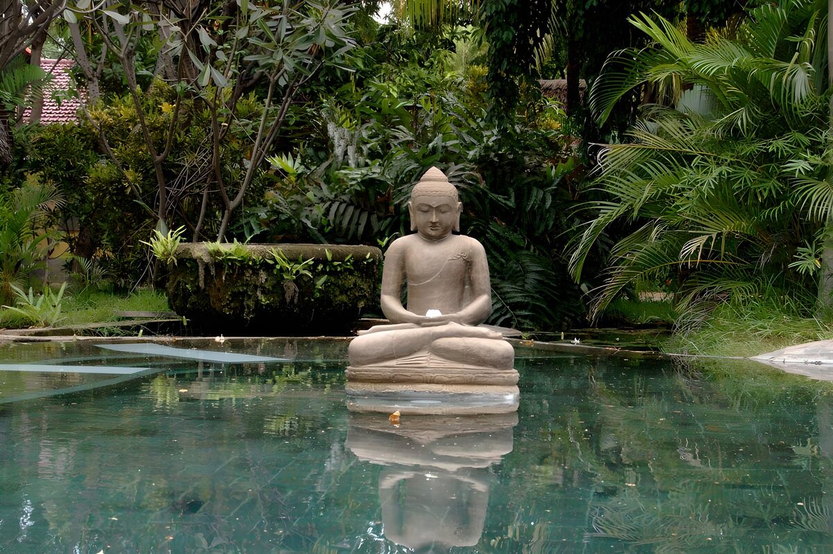 Buddha reflected in a garden pond