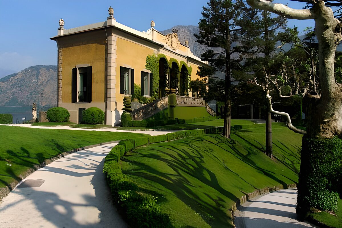 Yellow villa in a sunlit lakeside garden