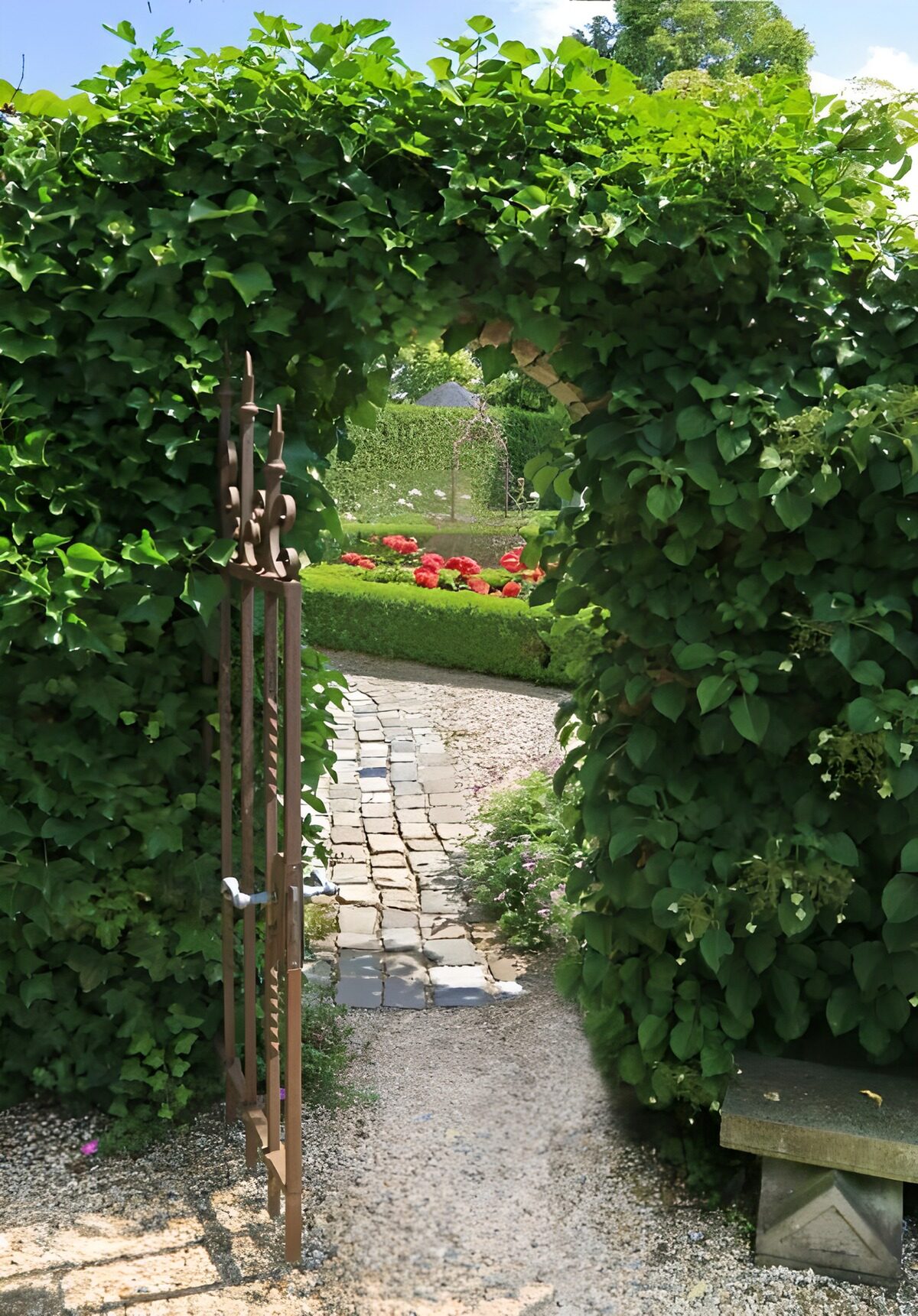Open gate to a sunlit flower garden