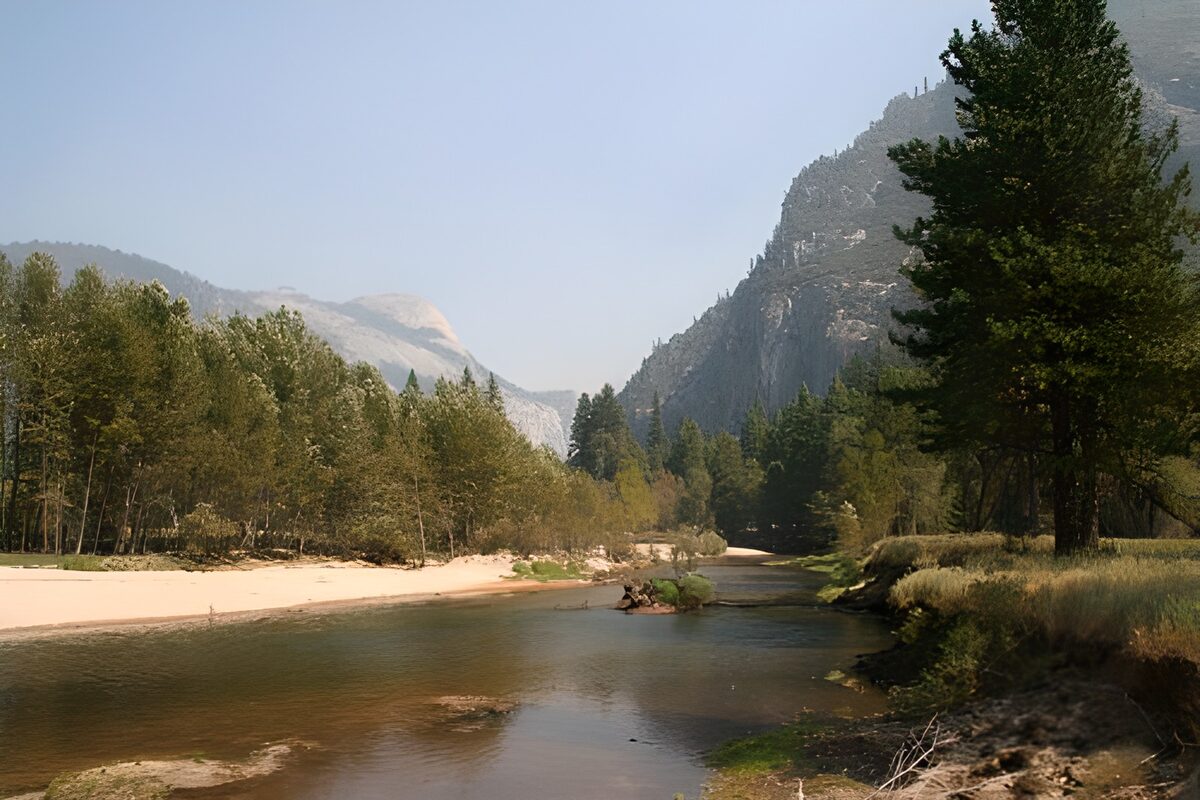 River bend beneath wooded mountains