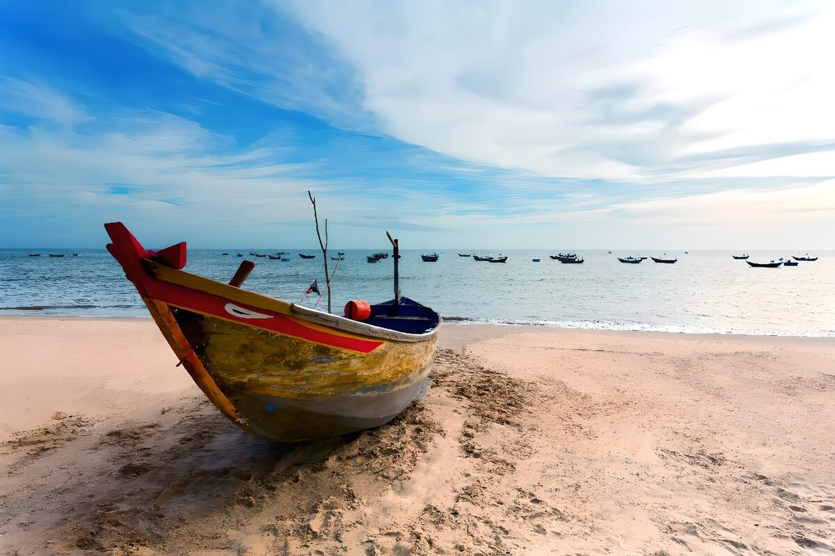 Weathered fishing boat on quiet sand