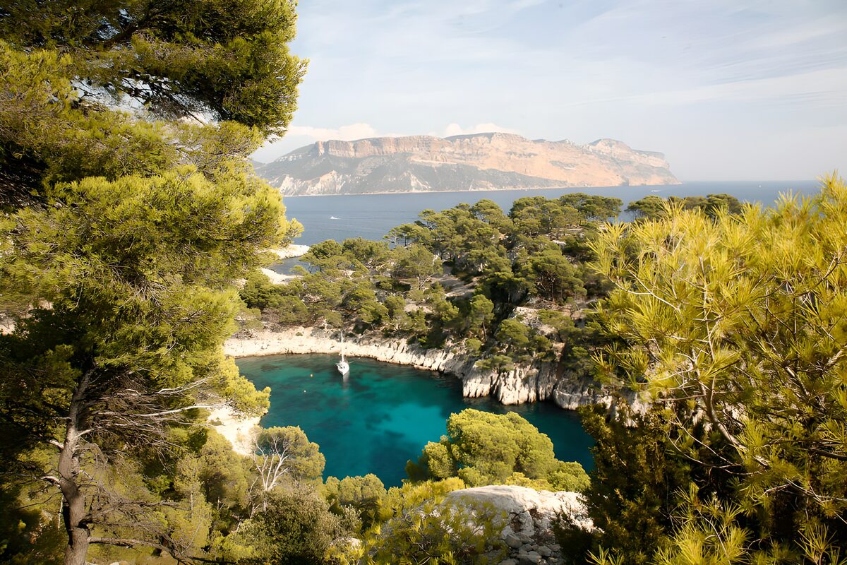 Sailboat in a sunlit turquoise cove