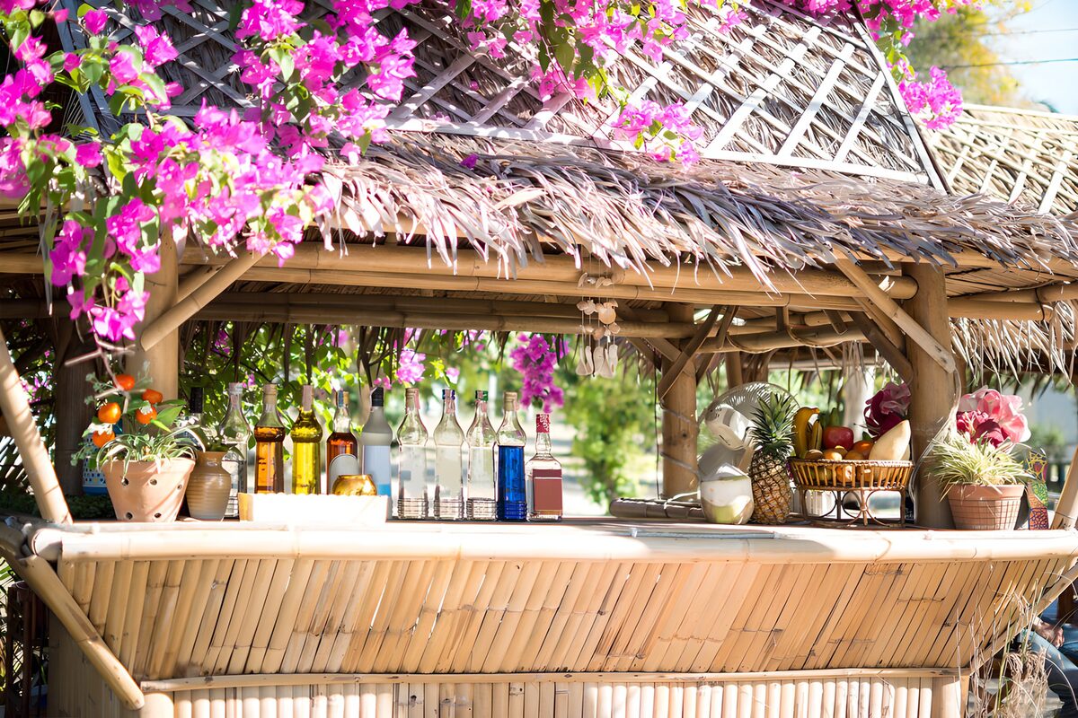 Sunlit bamboo bar with pink flowers