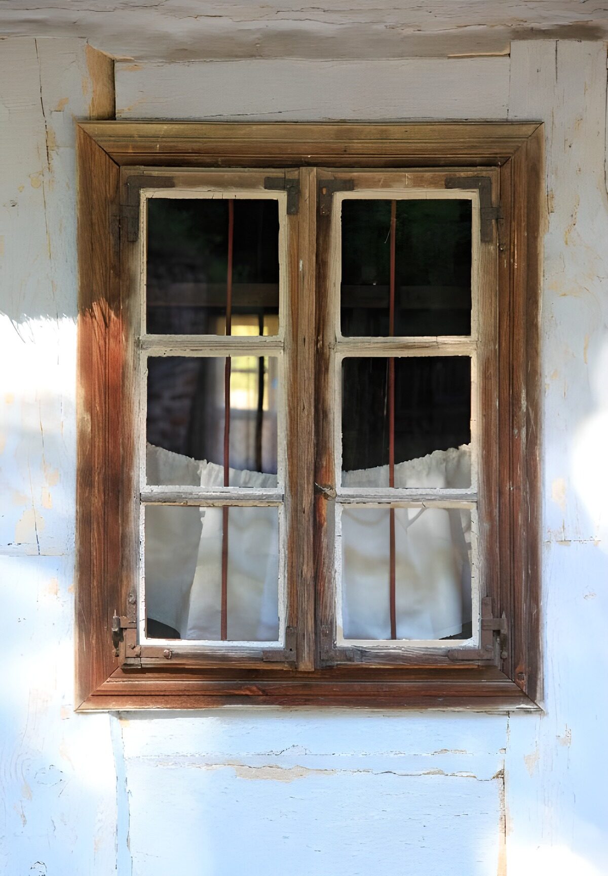 Old wooden window on a weathered wall