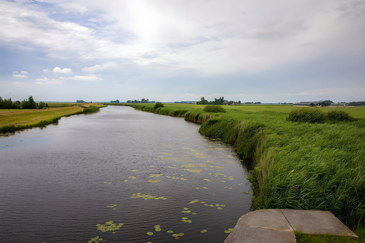 Quiet waterway through open fields