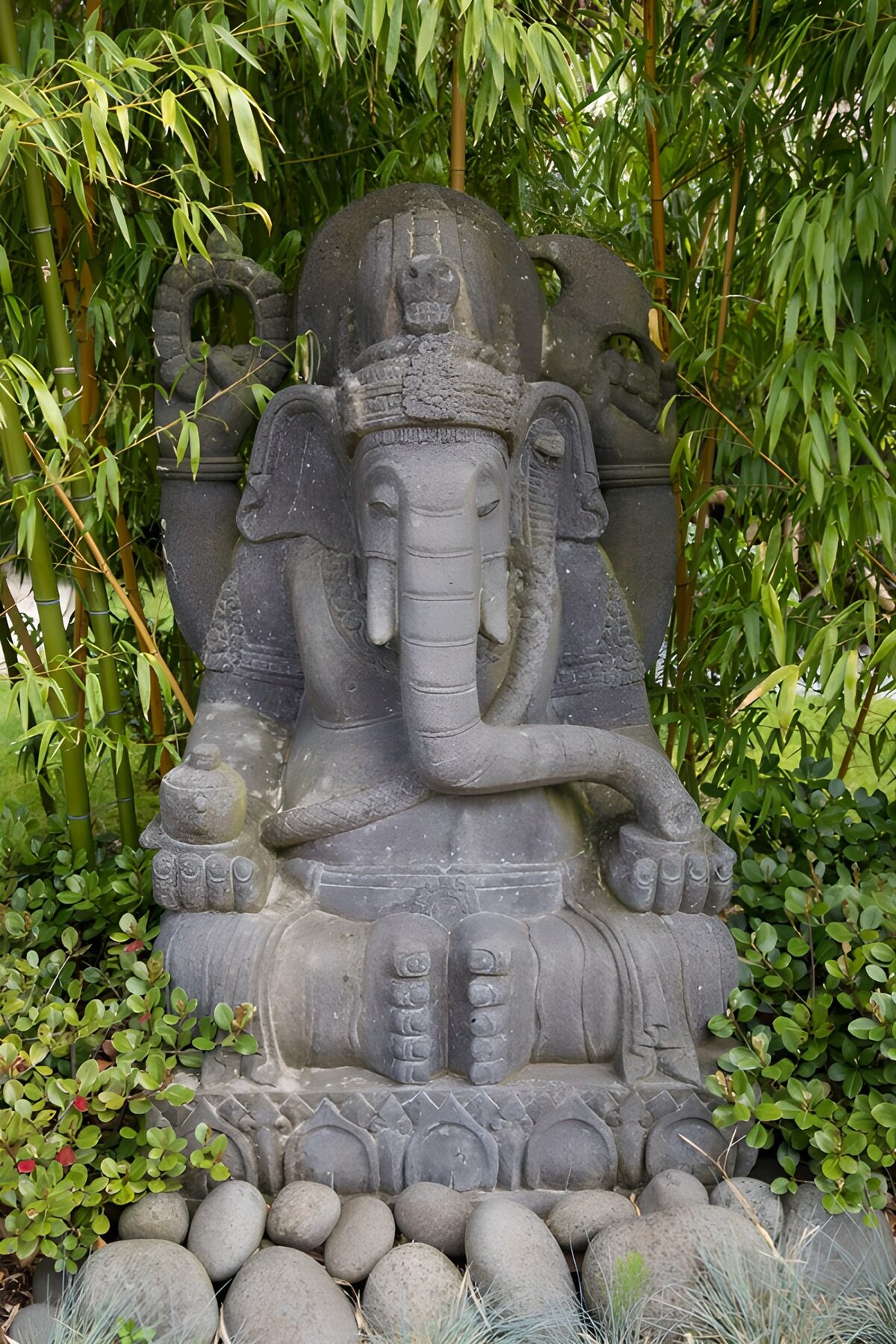 Grey stone Ganesha among bamboo