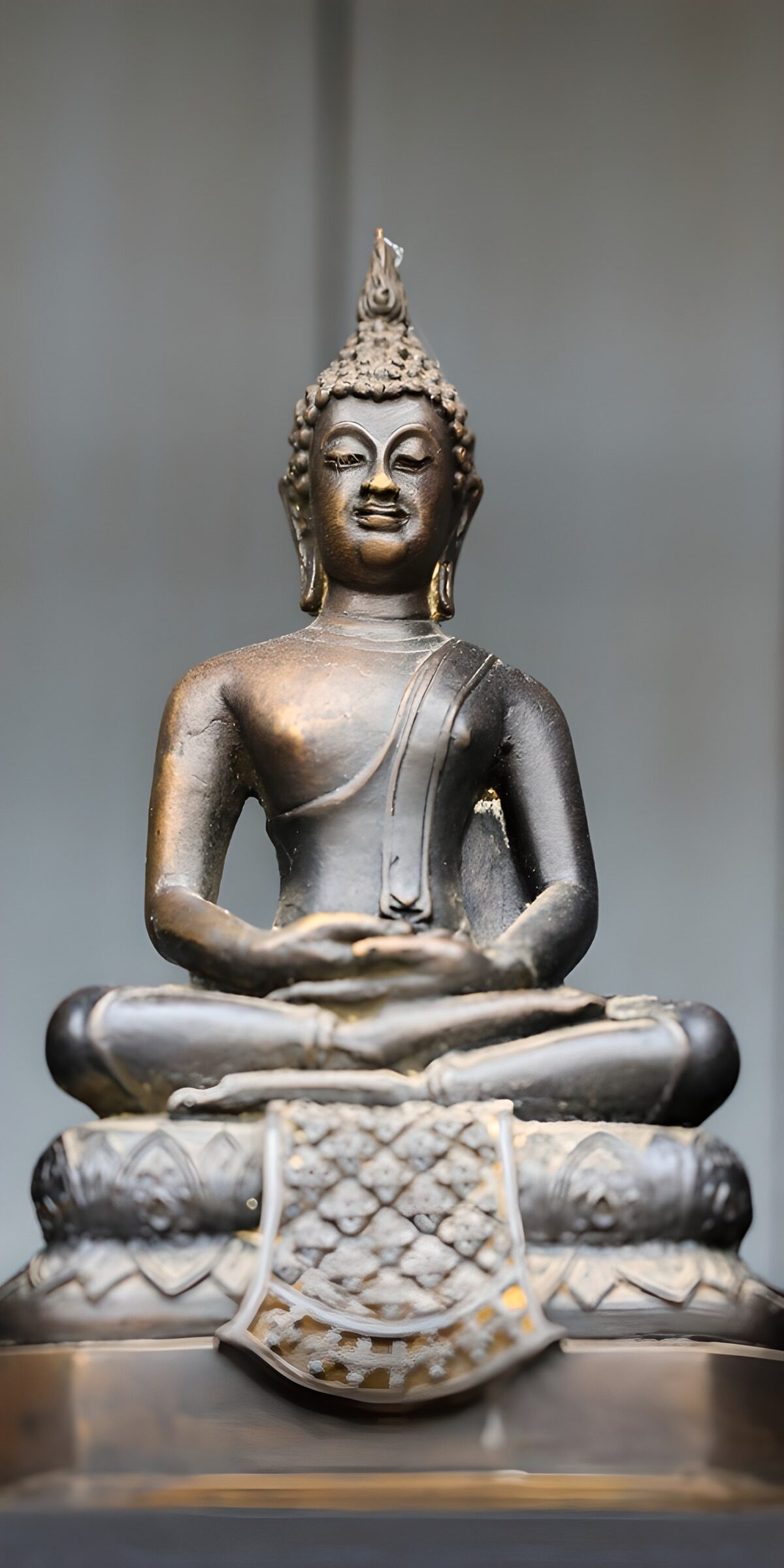 Seated bronze Buddha in soft light