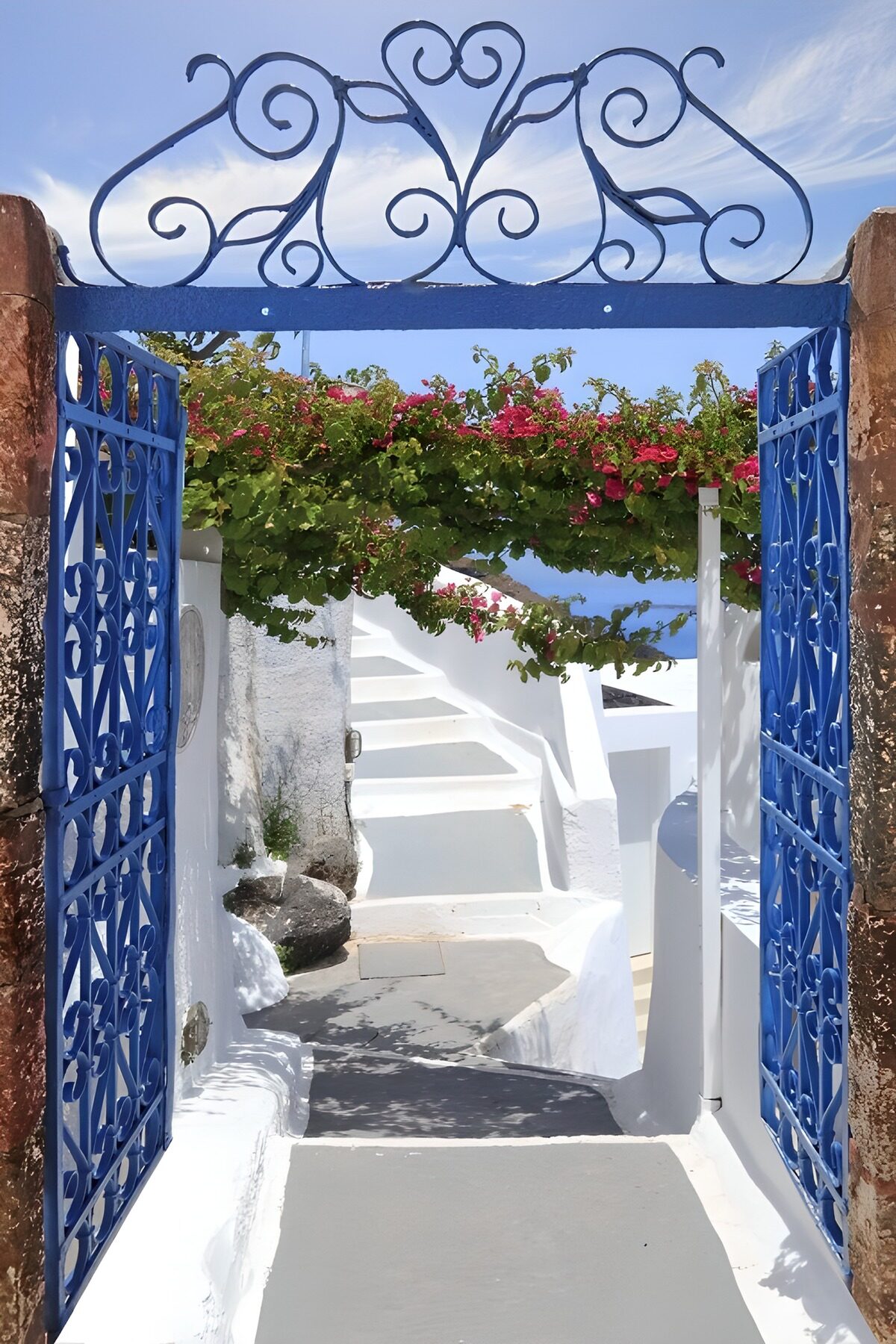 Blue iron gates and sunlit white steps