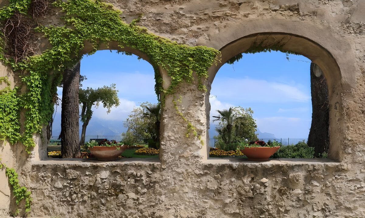 Old stone arches with a sunny garden view