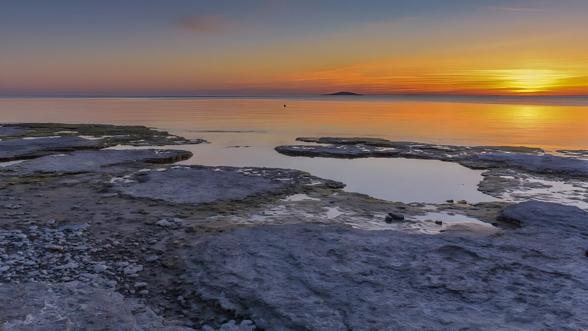 Rock shelves beside a sunset sea