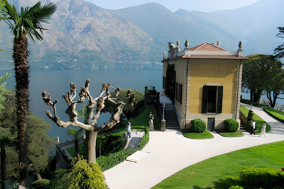 Yellow villa and sunlit lakeside garden