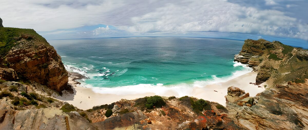 Turquoise cove beneath rugged cliffs