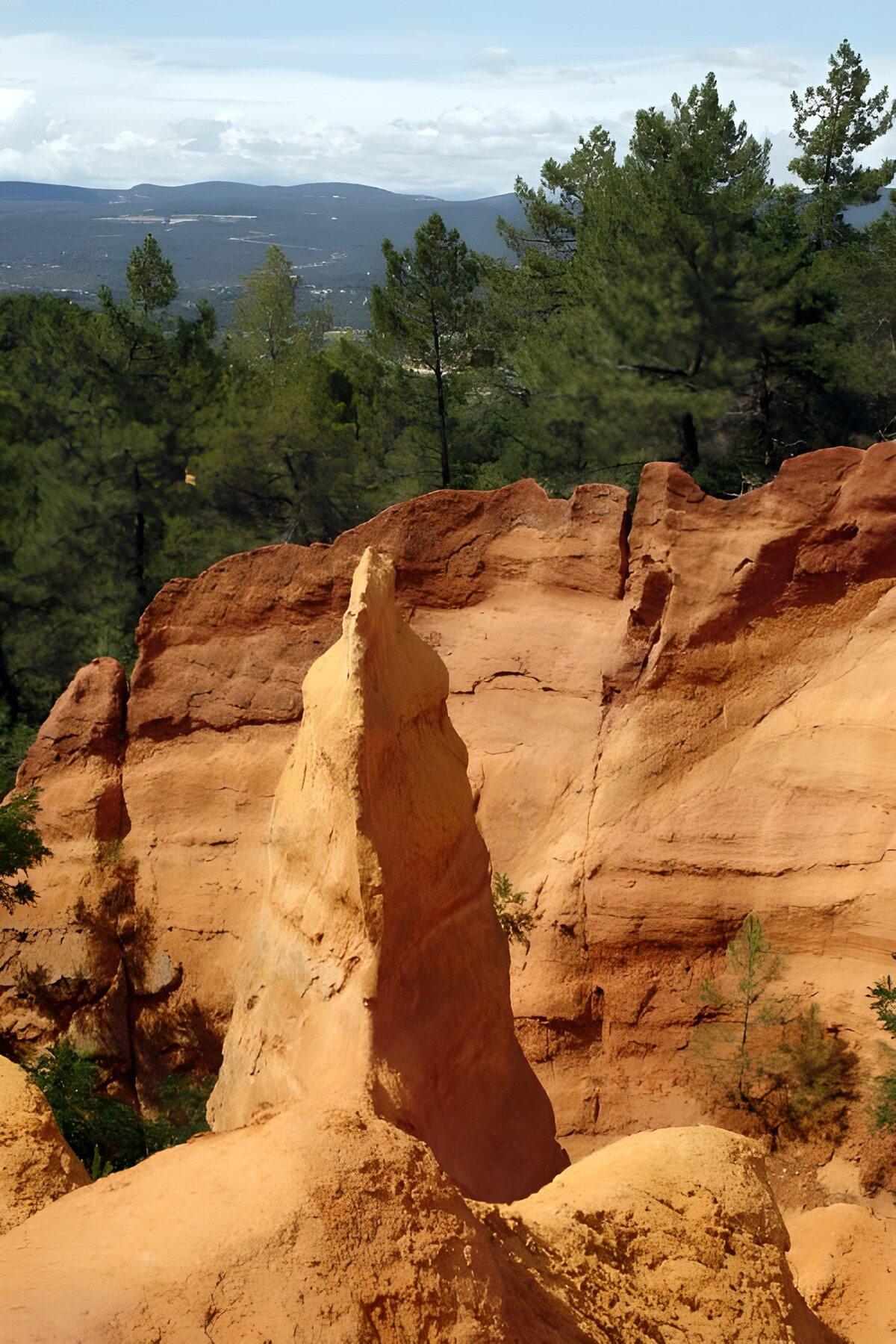 Sunlit rock pinnacle above the forest