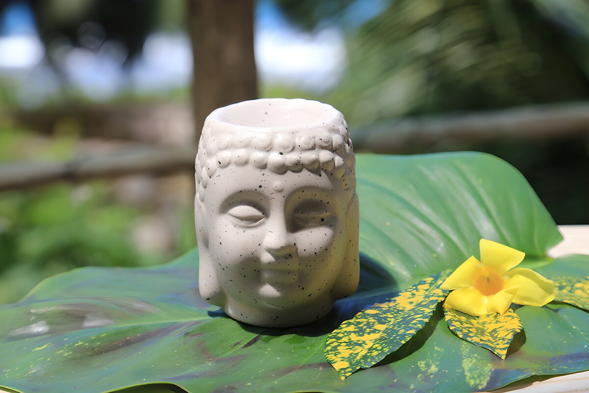 White Buddha head on a sunlit leaf