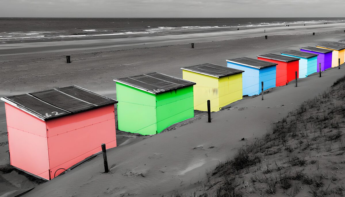 Colourful beach huts by a quiet sea