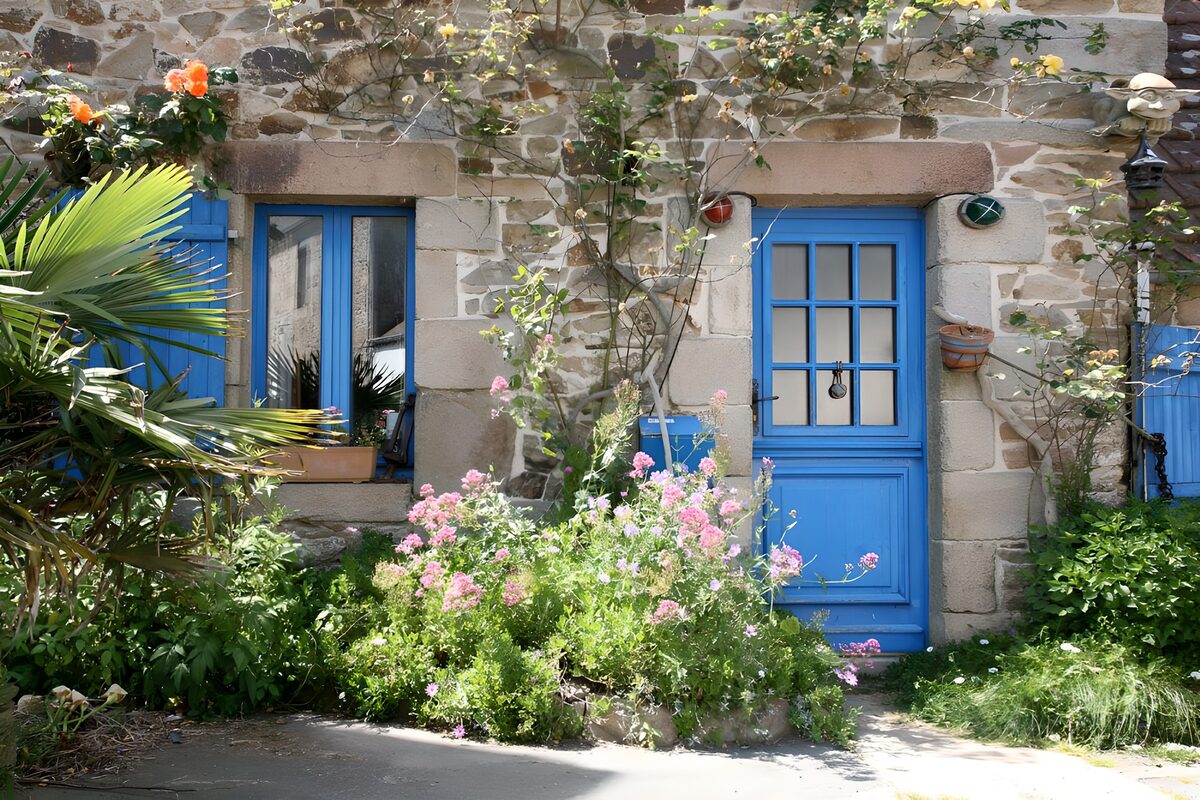 Blue door and pink flowers in the sun