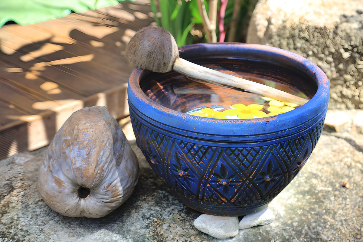 Blue water bowl with sunlit flowers