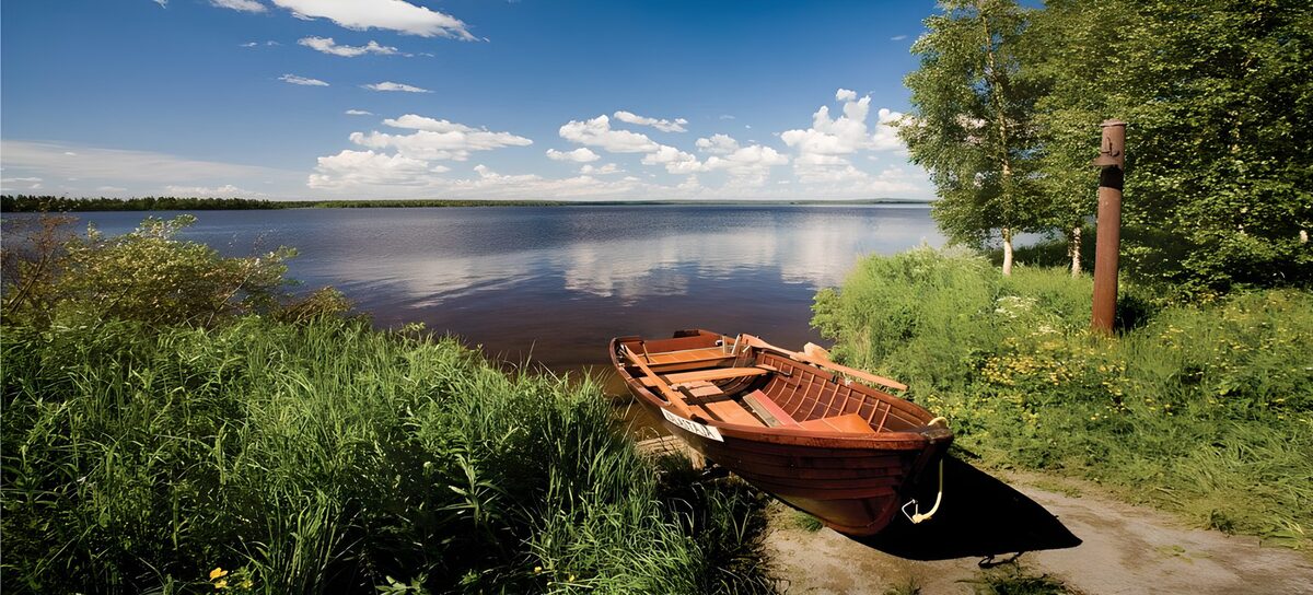 Wooden rowing boat on a summer shore