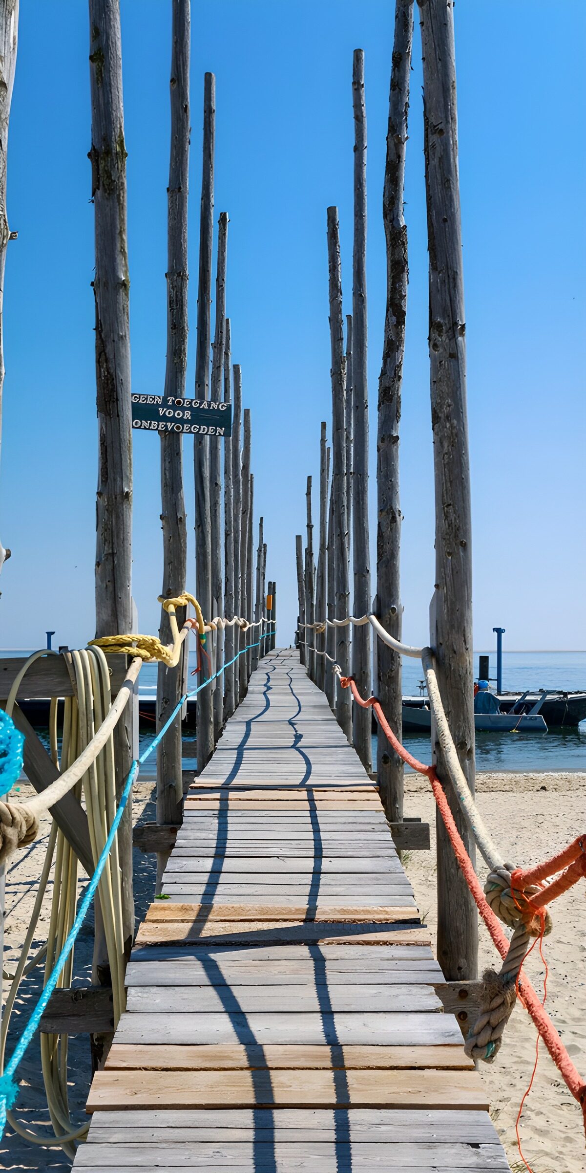 Weathered jetty beneath a cloudless sky