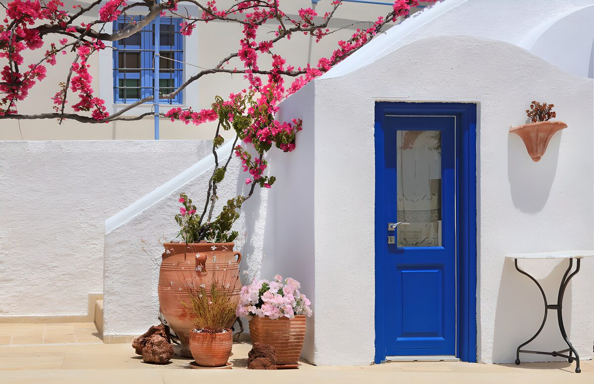 Blue door and bougainvillea in the sun