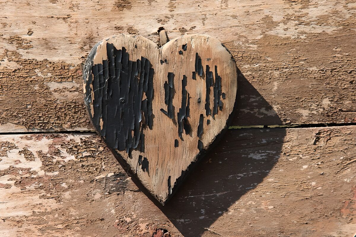 Weathered wooden heart in warm sunlight