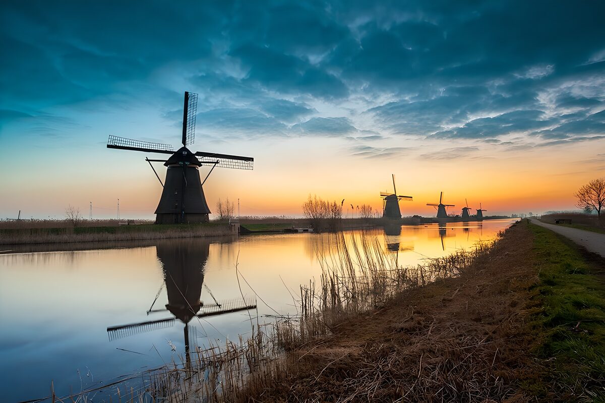 Windmills reflected in a twilight canal