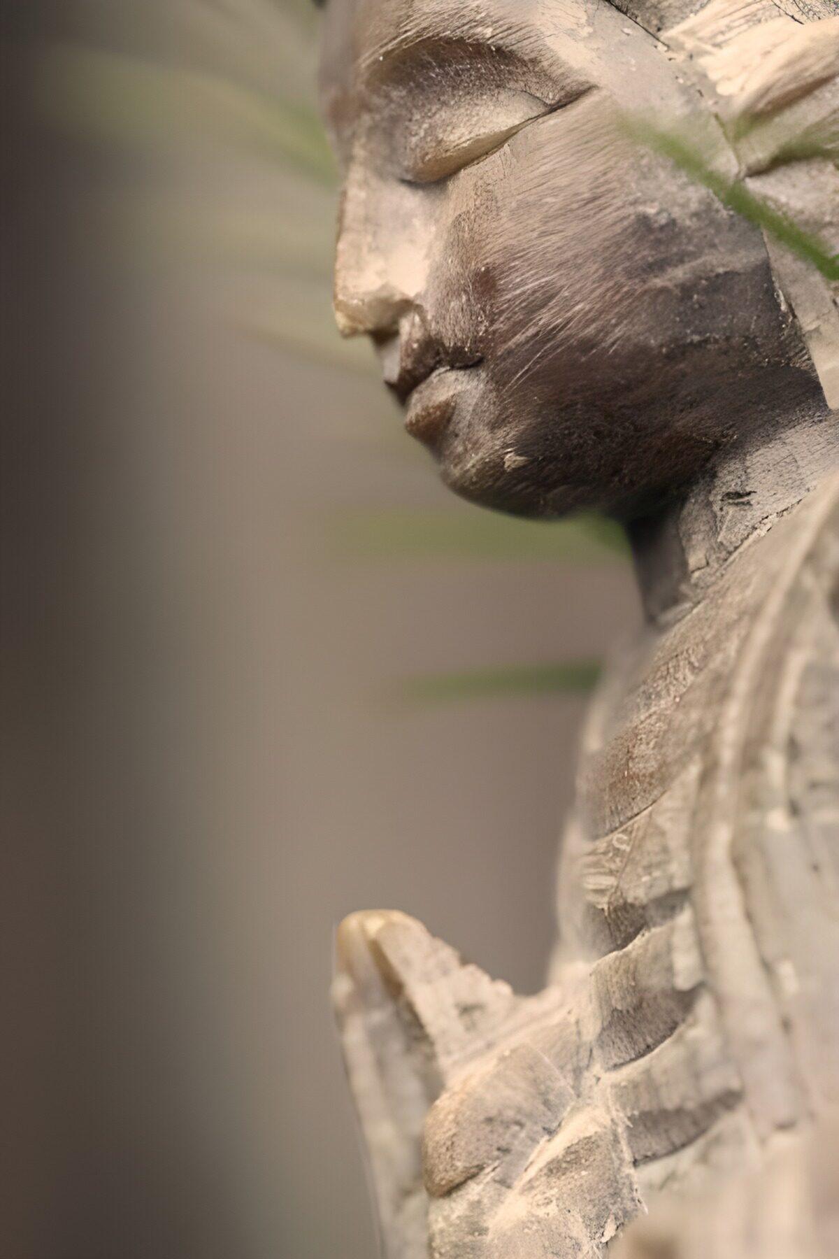 Wooden Buddha in quiet profile