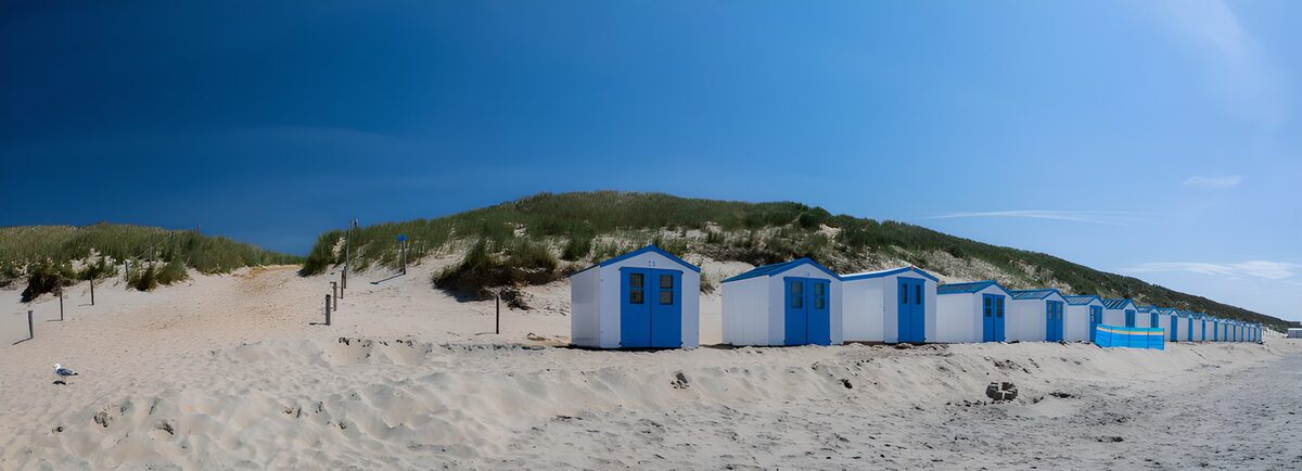 Blue and white beach huts in the sunshine