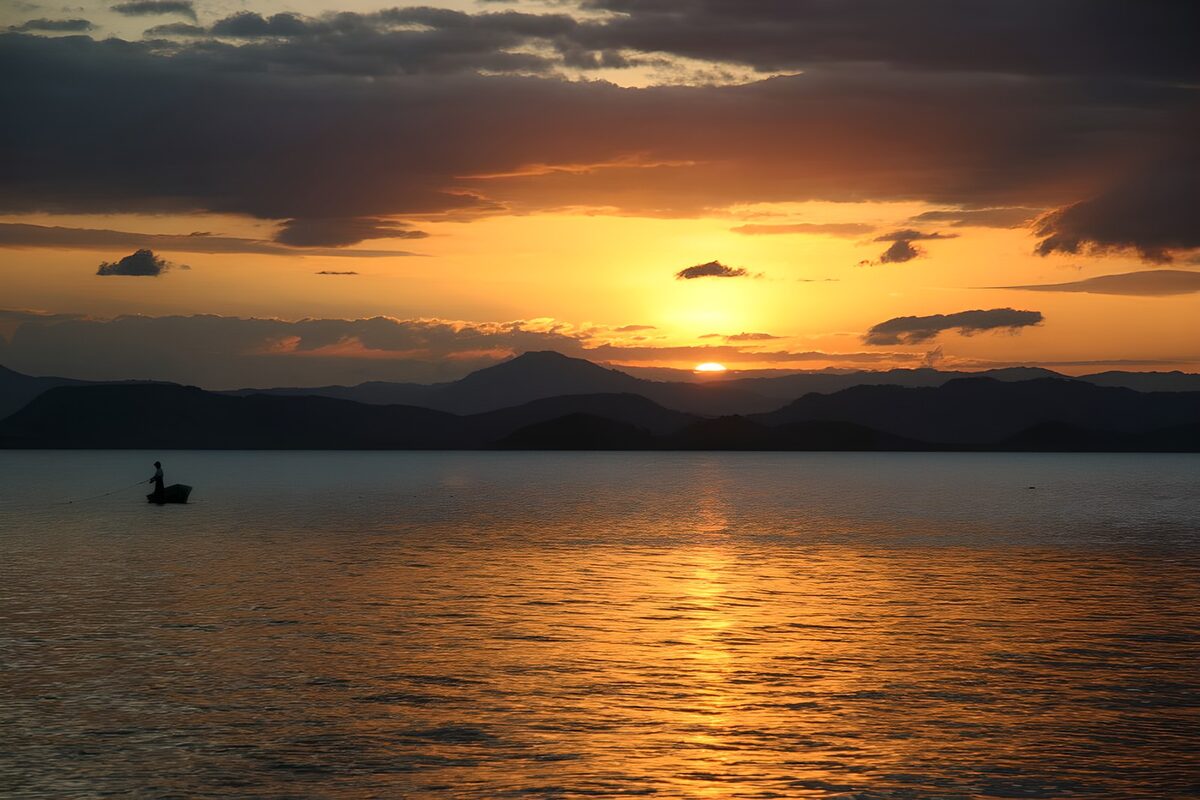 Fishing boat on golden sunset water