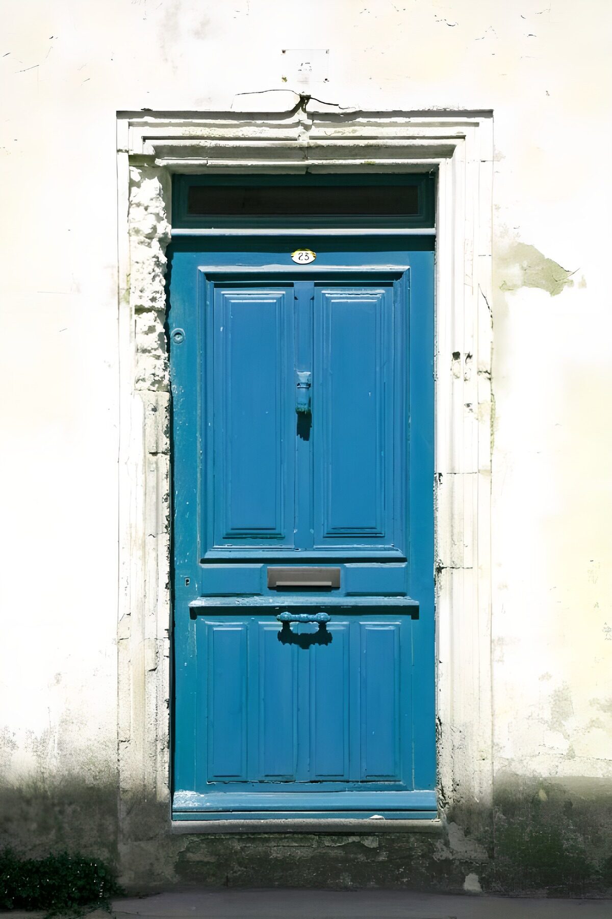 Weathered blue front door in the sun