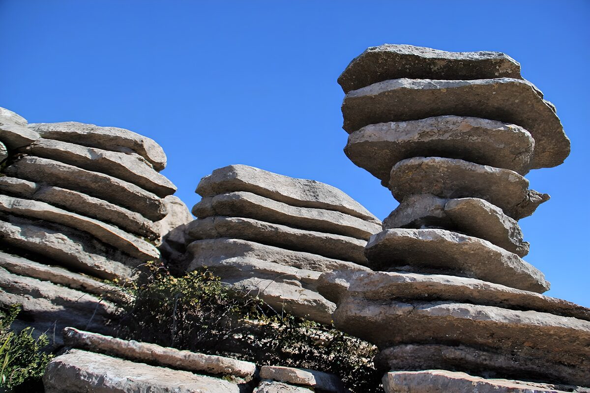 Sunlit rock stacks against a blue sky